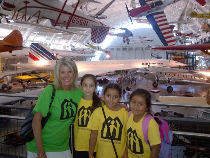 Volunteer Marilyn Whitehurst poses with three children in our summer program at the Udvar-Hazy Center, National Air and Space Museum in Dulles.